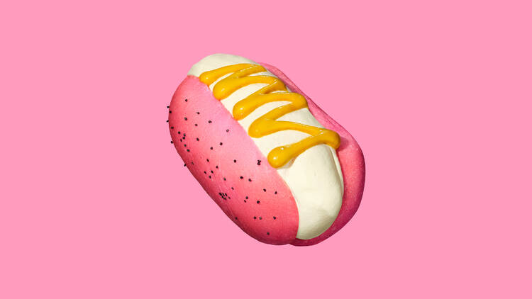 Hot dog-flavored ice cream served in a pink bun with mustard