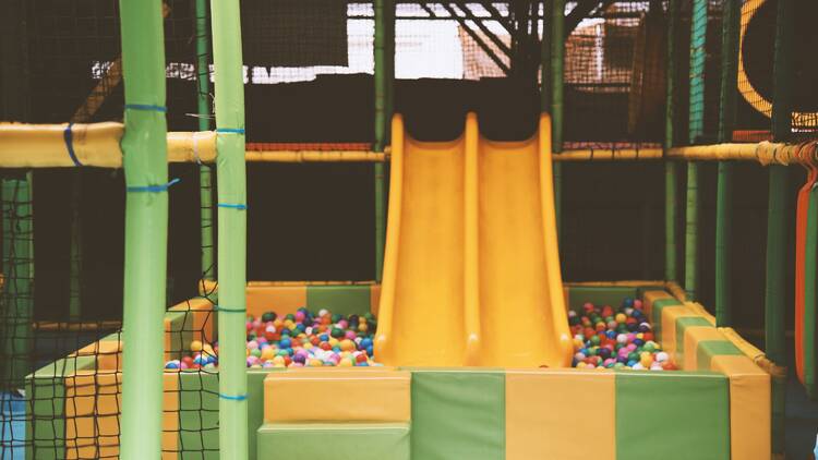 An indoor play centre with a slide and ball pit.