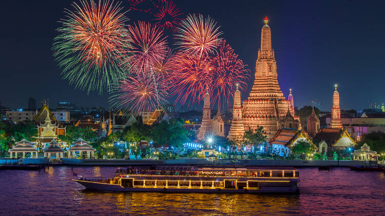 Wat arun and cruise ship in night time under new year celebration, Bangkok city ,Thailand