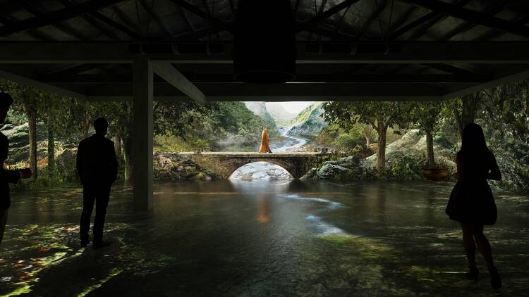 Two people look at a digital art installation which projects a serene forest with a monk walking over a bridge
