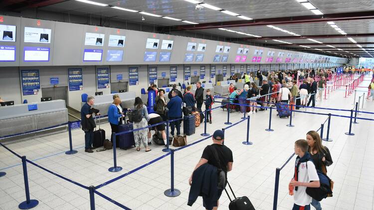 People queuing for a check-in line at the airport.