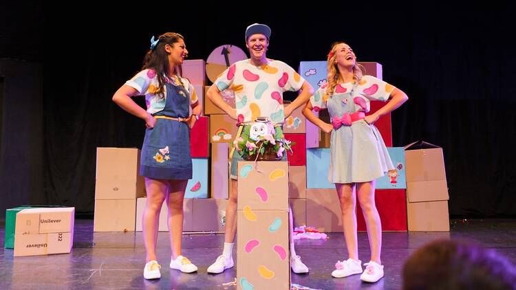 Two women and a man in a kid's theatre production