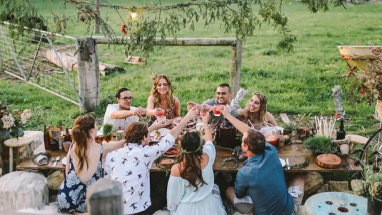 A group of friends at a table in a paddock