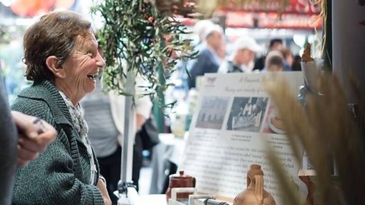 Lady smiling whilst looking at market stall 