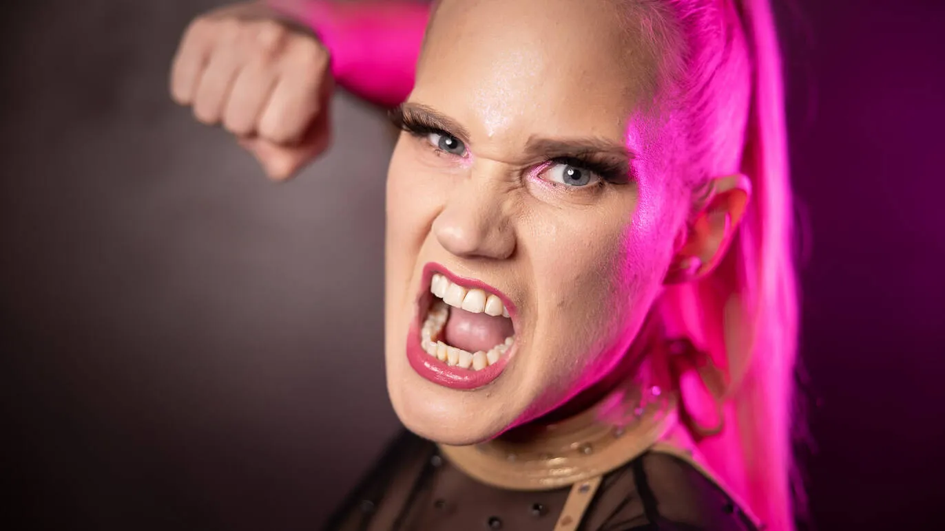 Wrestler Shazza McKenzie raises a fist to the camera