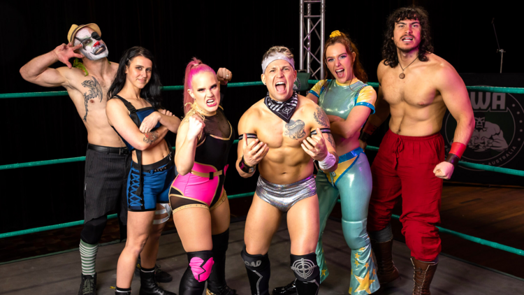 A group of wrestlers from Pro Wrestling Australia stand in the ring