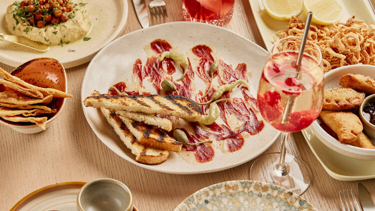 A platter of jamon iberica with toasted bread. 