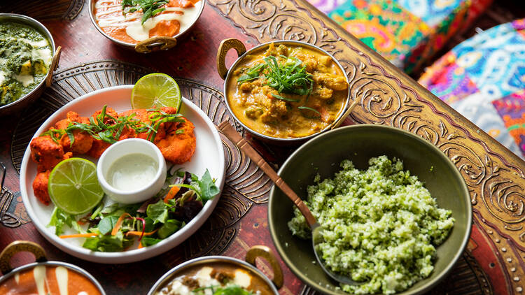 A colourful spread of curries and meals laid upon a table at Its Mirchi