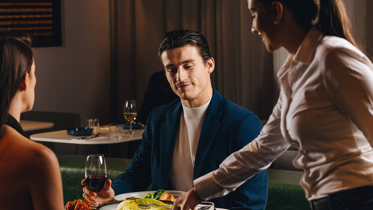 A couple dining at a hotel restaurant.