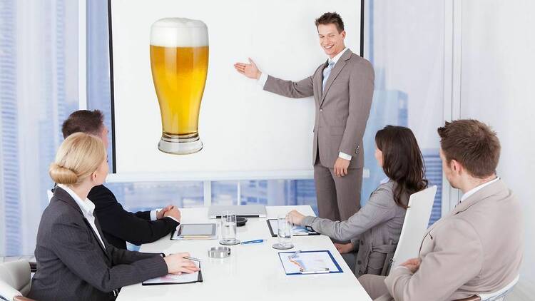 A man presenting to a group of other employees in a workplace.