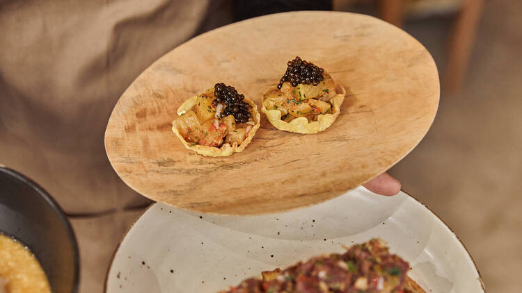 Two small entrees topped with smoked fish roe.