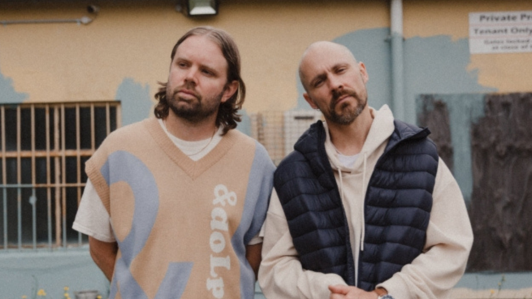 DJ duo Hermitude pose against a painted wall