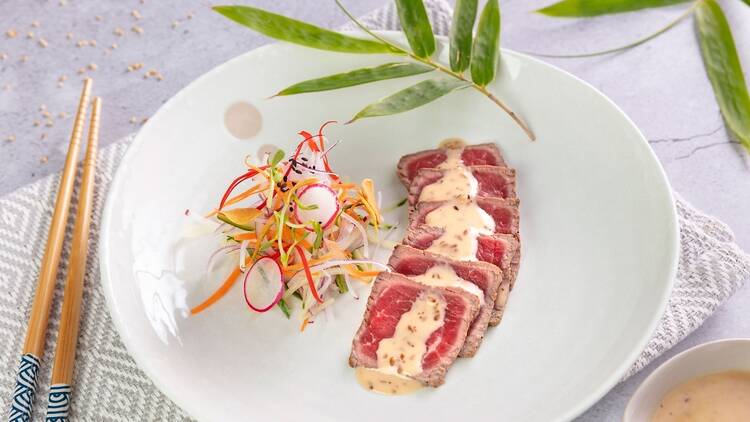 A plate of thin sliced beef tataki, Japanese style