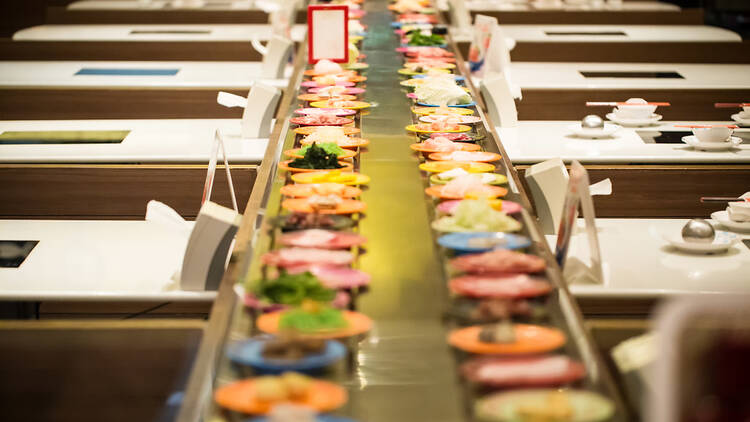 Plates move around on a sushi train