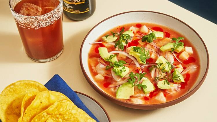 A bowl of Aguachile Rojo with a Modelo. 