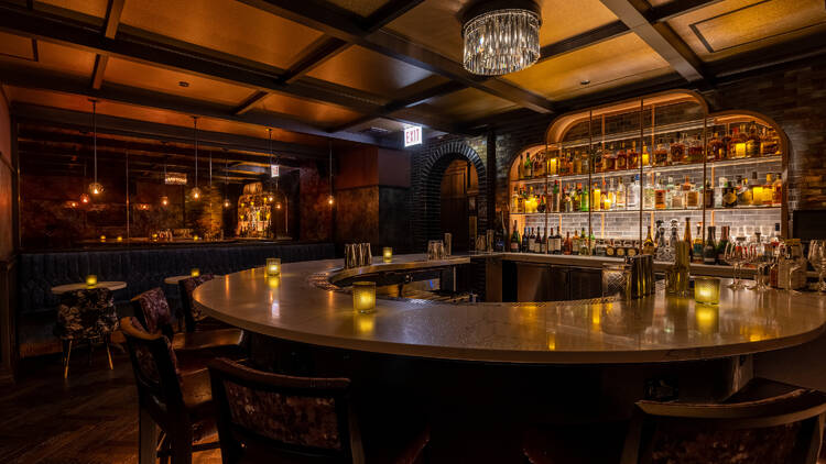 A circular bar lit with candles at Rose Lounge