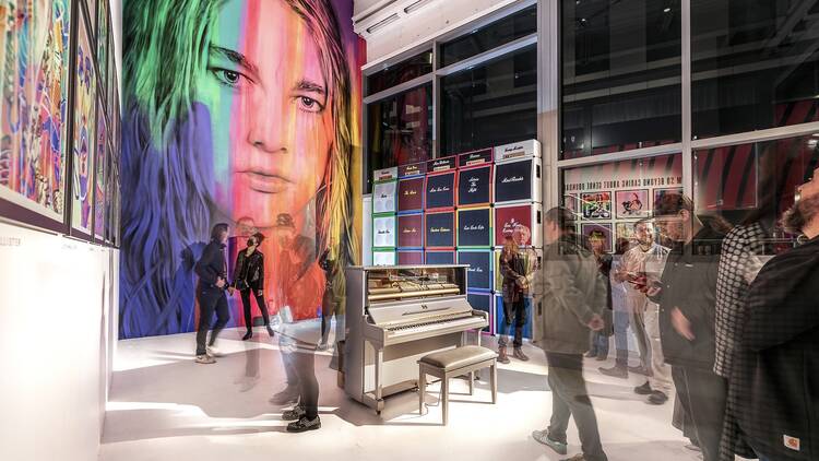 A huge mural of Daniel Johns in rainbow colours features on a far wall of his latest exhibition