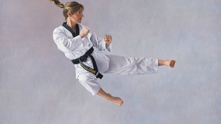 A painting of a woman mid-jump in a white taekwondo outfit.