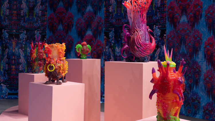A collection of strange colourful sculptures sit on top of pink plinths 