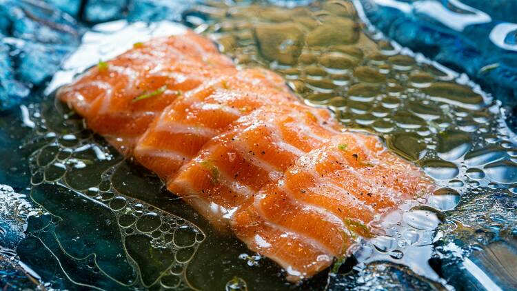 Four slices of salmon tiradito.