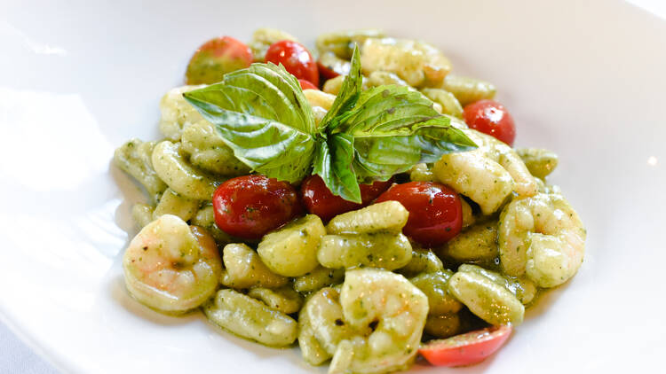 A bowl of cavatelli with shrimp.