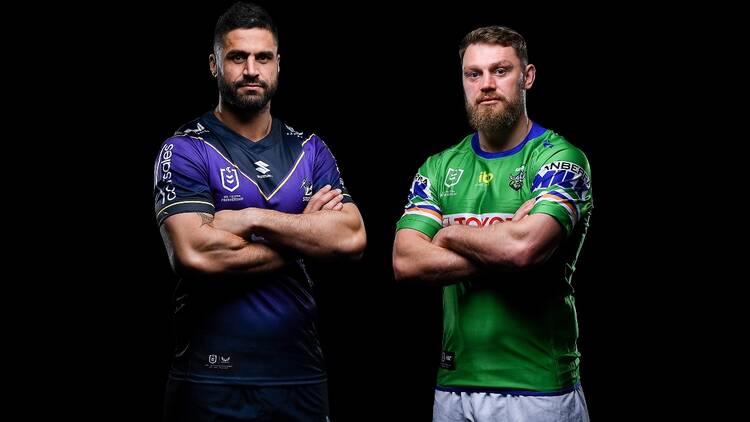 Two NRL players, one from the Storm and the other from the Raiders and standing upright and crossing their arms