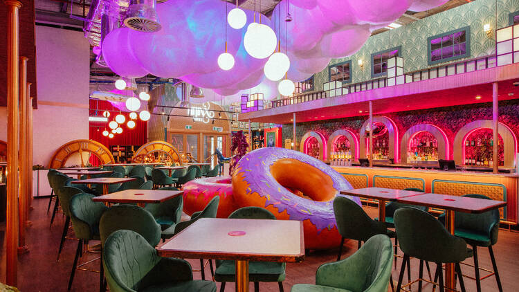 A cocktail bar with decorative inflatable doughnuts and fairy floss.