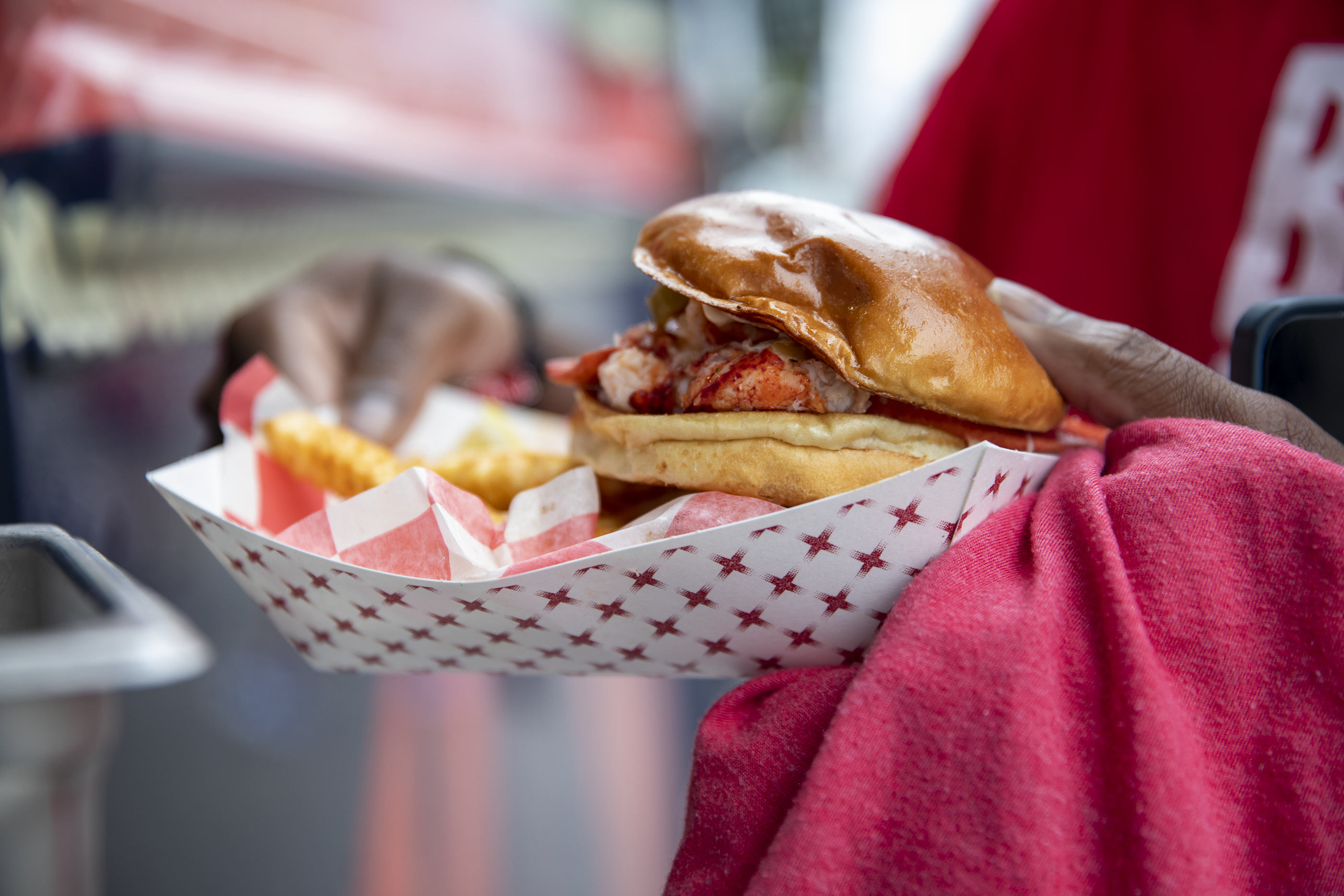 A person holds a sandwich at Bulls Fest