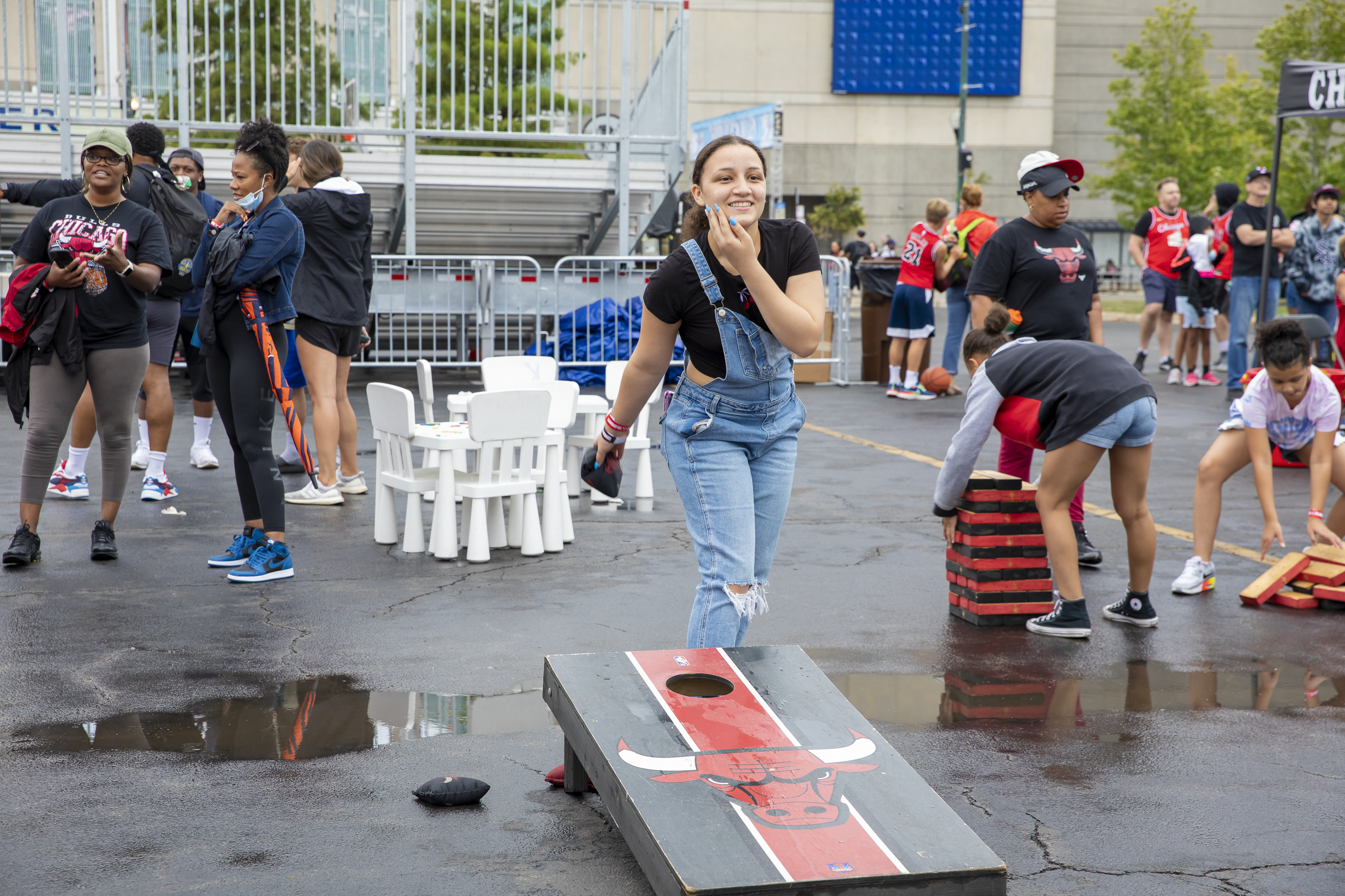 A person playing cornhole toss at Bulls Fest