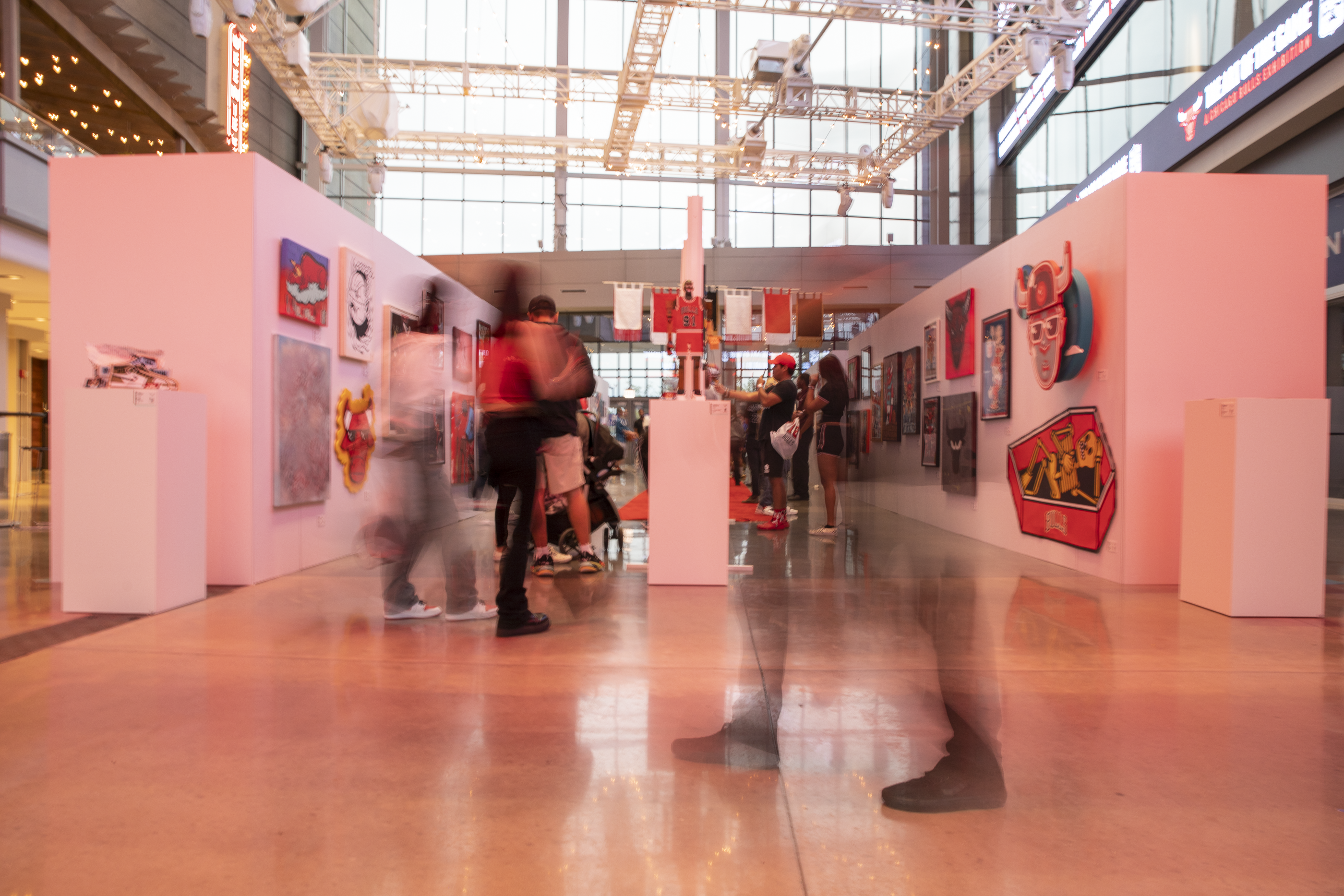 People move throughout an art gallery at Bulls Fest