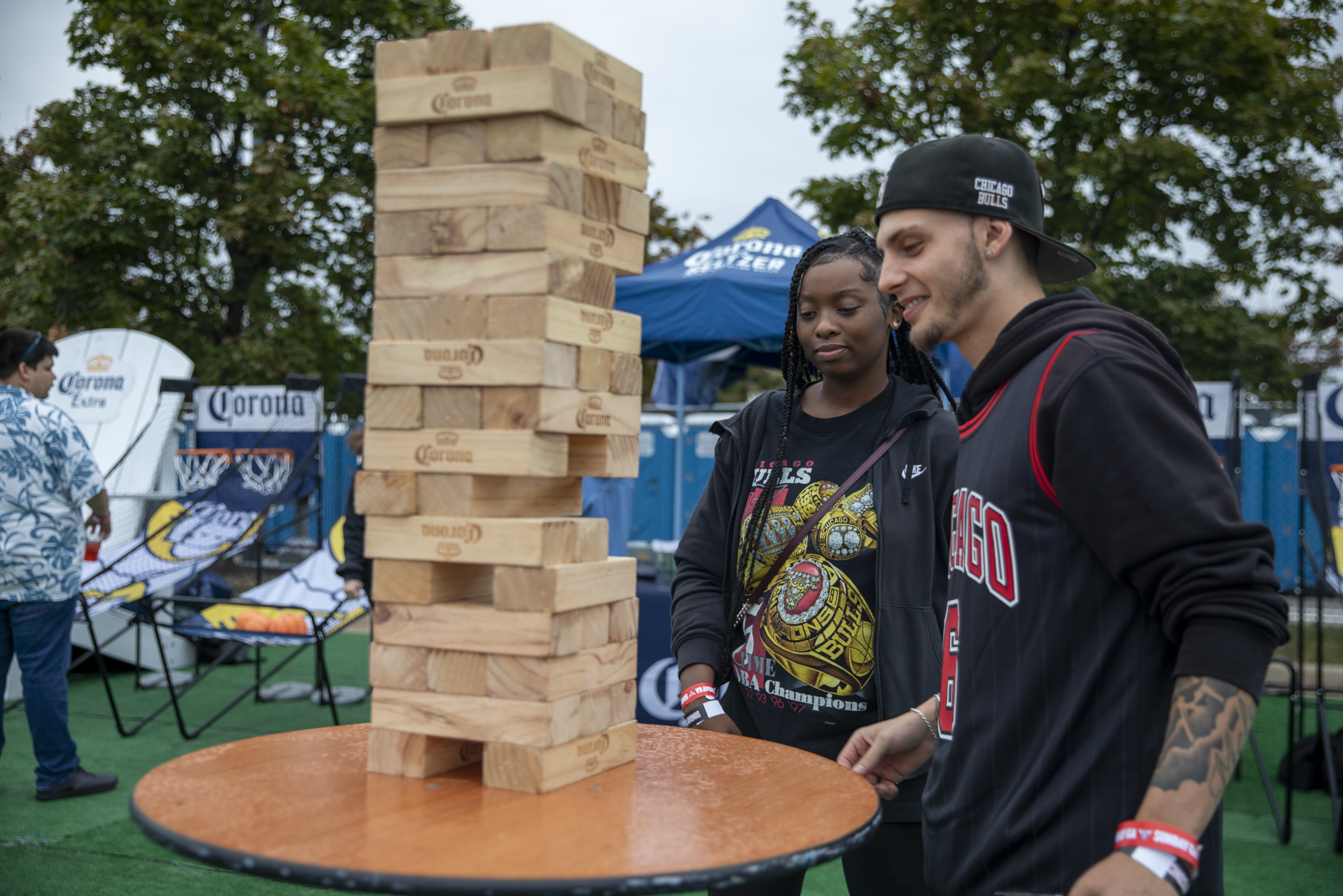 Two people play large-scale Jenga at Bulls Fest