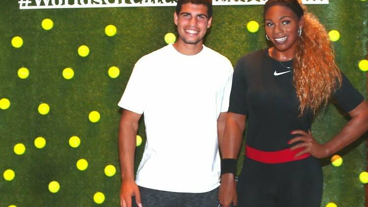 World famous tennis player Carlos Alcaraz poses for a photo with the wax sculpture of Serena Williams.