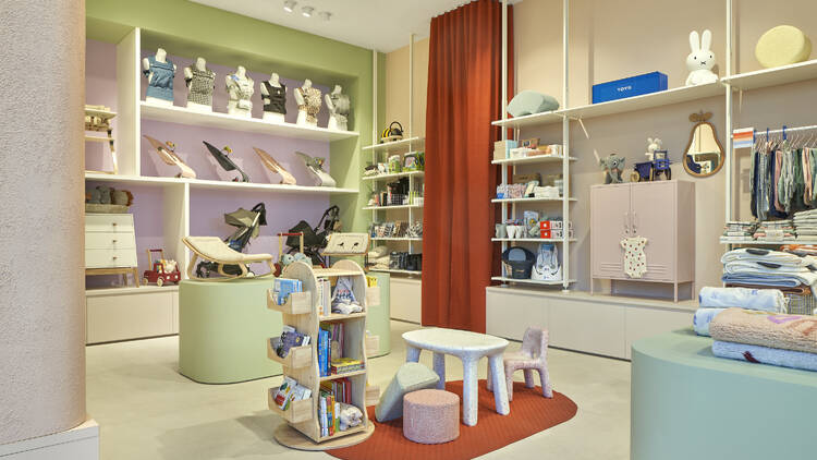 The interior of a boutique baby shop, featuring shelves lined with baby goods.
