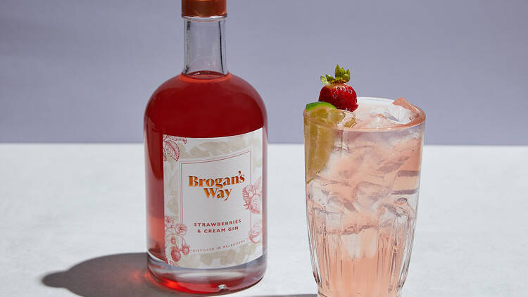A bottle of Brogan's Way Strawberries and Cream Gin and a pink gin and tonic