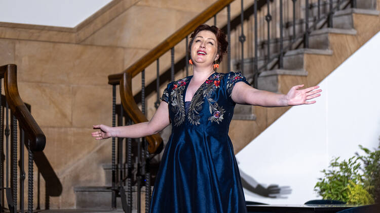 An opera singer singing in Luci's dining room.