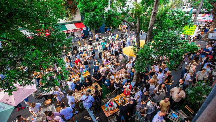 Hundreds of people are on the streets enjoying outdoor dining and drinking