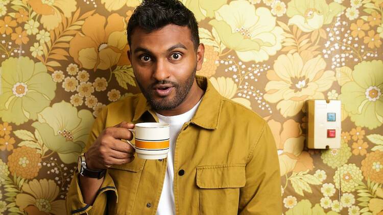 Comedian Nazeem Hussain holding a mug