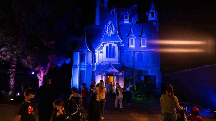 A haunted house illuminated in blue lights.