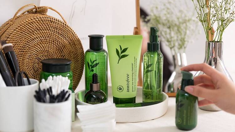 A bathroom vanity with Innisfree products, including cleanser, toner and moisturiser.