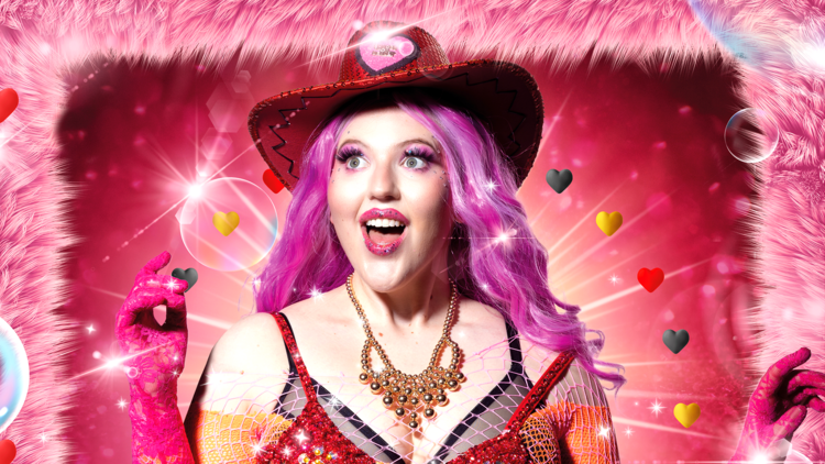 Woman wears a pink wig and glittery red cowboy hat and costume