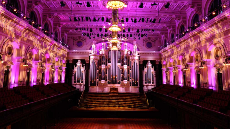 A photo of the inside of Town Hall lit up in pink neon lights