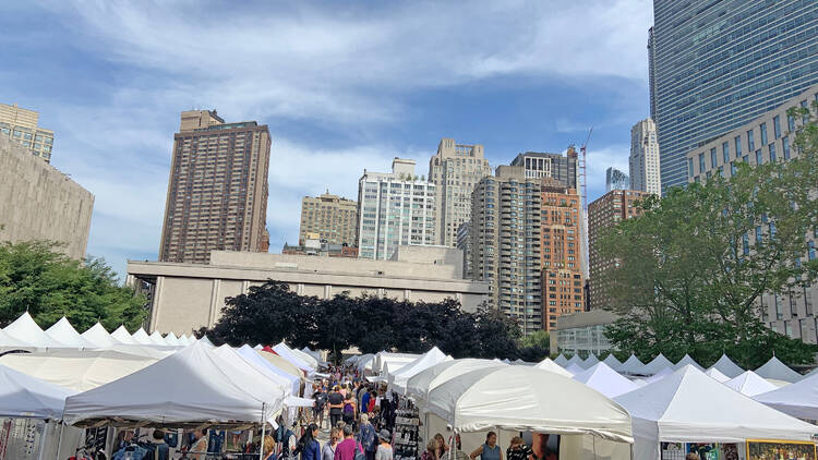 Craft tents with the city skyline in the background.