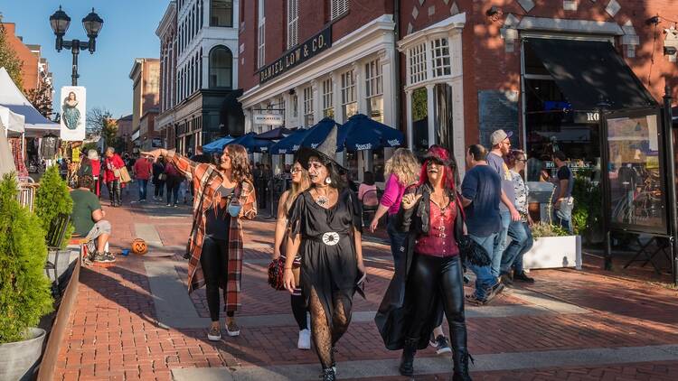 People dressed in costumes at the annual Haunted Happenings event held during the month of October in celebration of the town's history of witch trials and Halloween. 