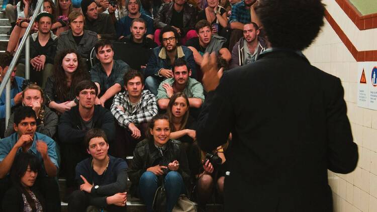 Slam poetry performance in a subway staircase