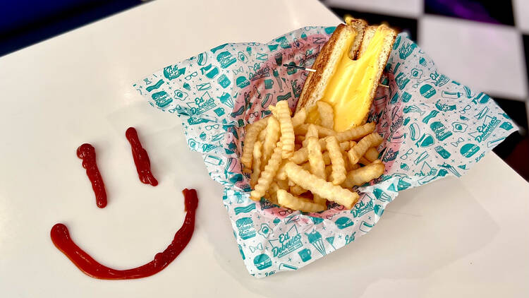 A basket of grilled cheese and fries.