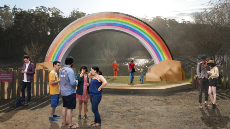 A render of people standing around a giant rainbow.