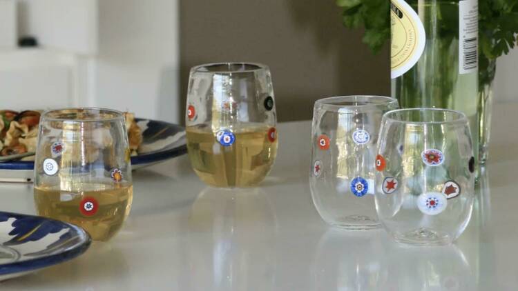 An array of glass cups with floral patterns.