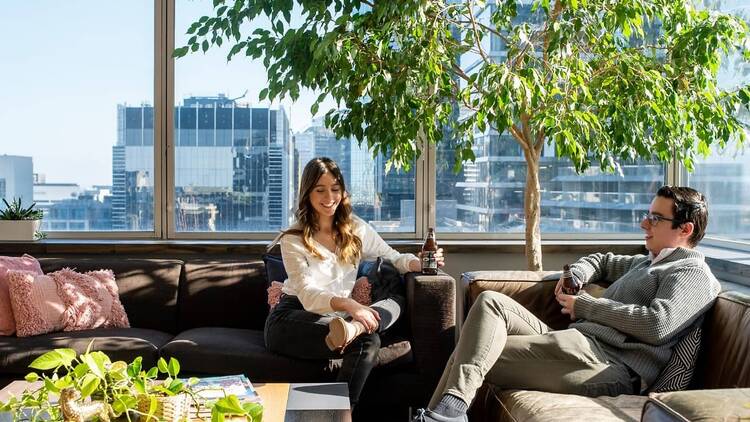 Two people sitting on couches in CBD co-working space, Cluster.