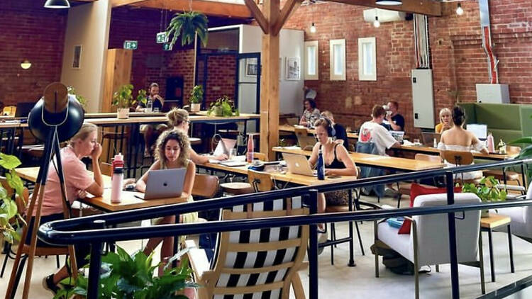 A co-working space in the CBD filled with people working independently.