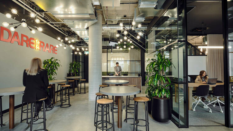 A co-working space with people working at hot desks.